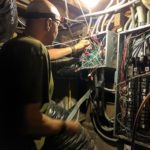 My Quiet Home's William Holland inspects wiring and grounds during an EMF mitigation project